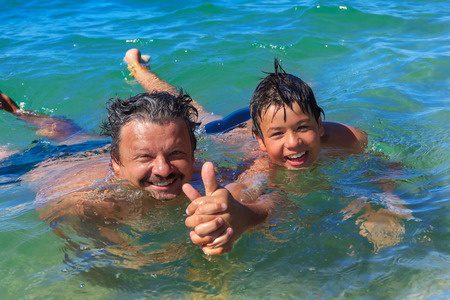 27354855 - dad and son swim in the sea
