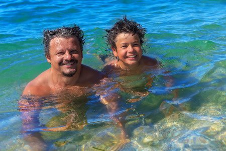 27354856 - dad and son swim in the sea